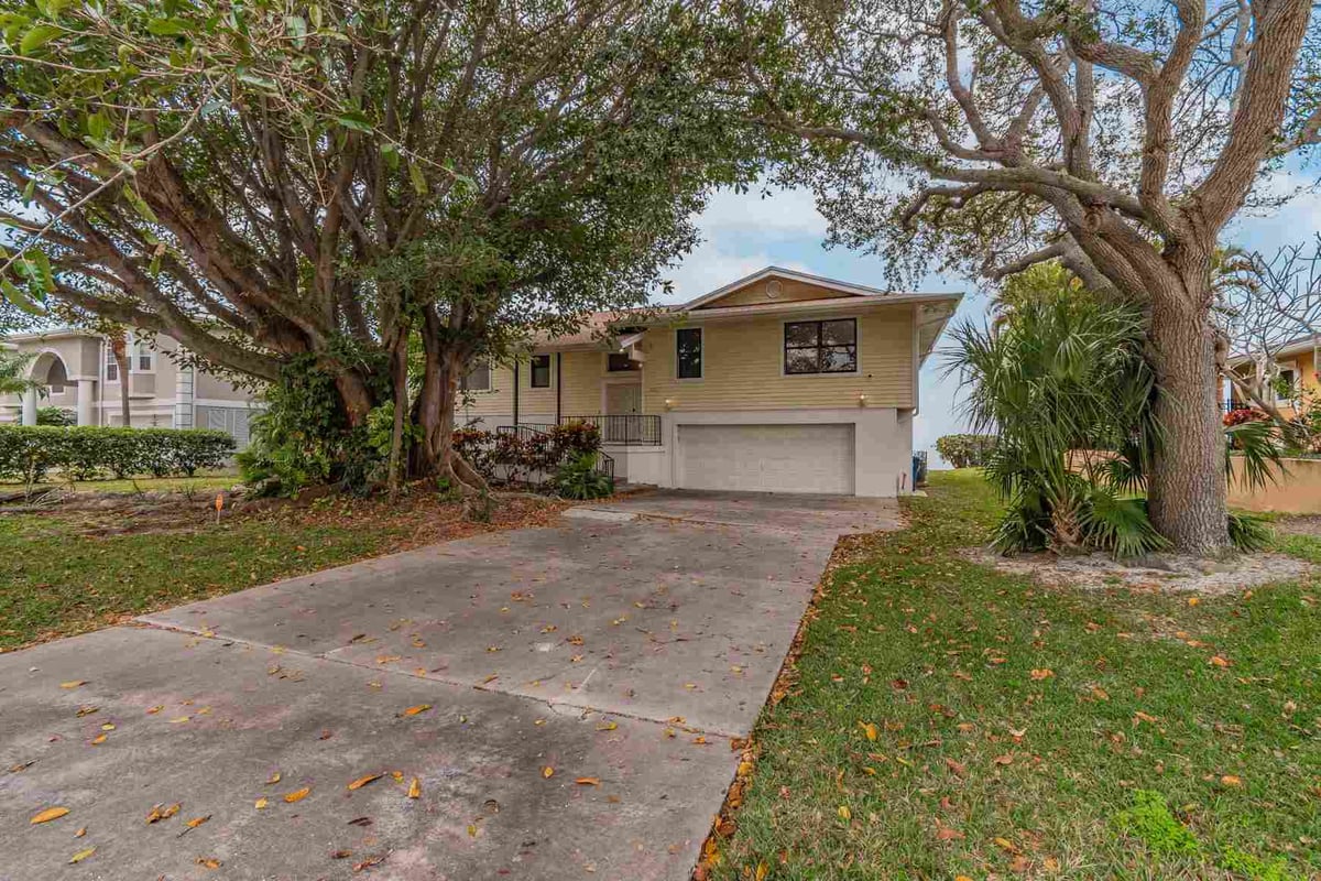 before waterfront renovation bradenton front exterior concrete driveway