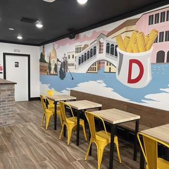 Dalmoros Sarasota, FL restaurant interior dining area venice mural yellow chairs
