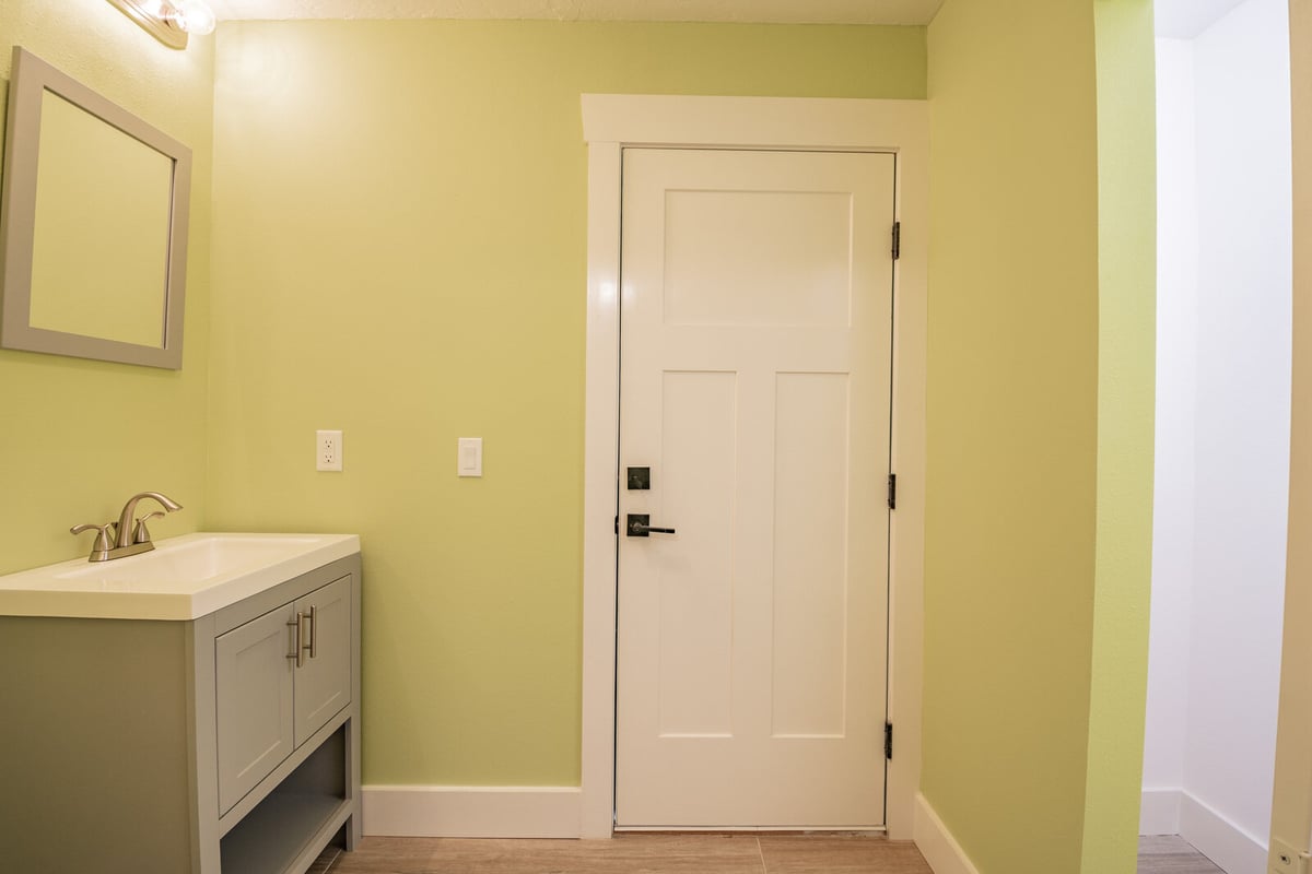 avenida madera bathroom with green walls and vanity