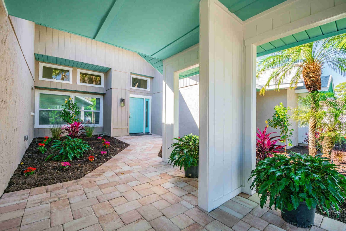 avenida madera courtyard entry with teal front door