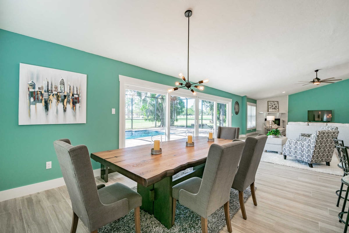 avenida madera dining room with teal wall and city art