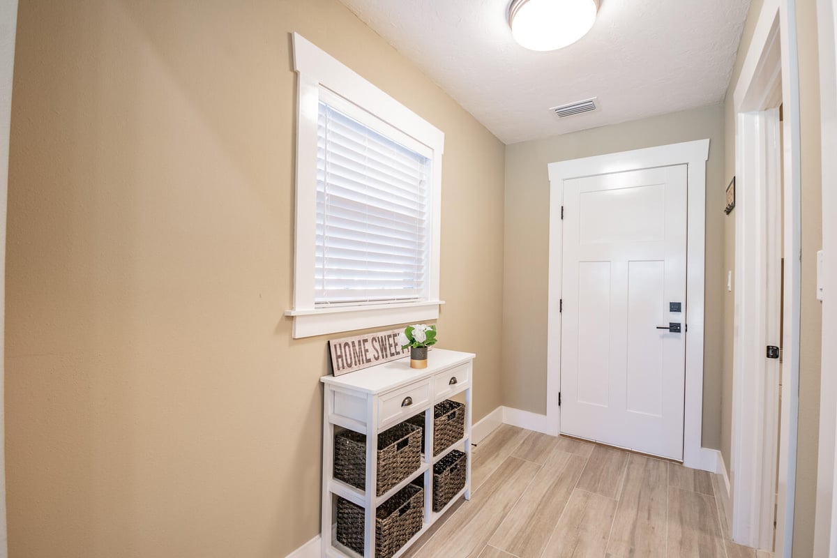 avenida madera entryway hall with front door and console table