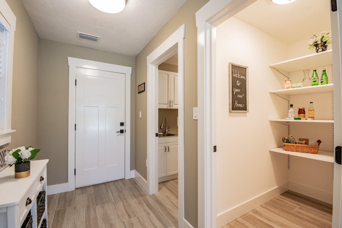 avenida madera entryway hall with pantry and welcome sign