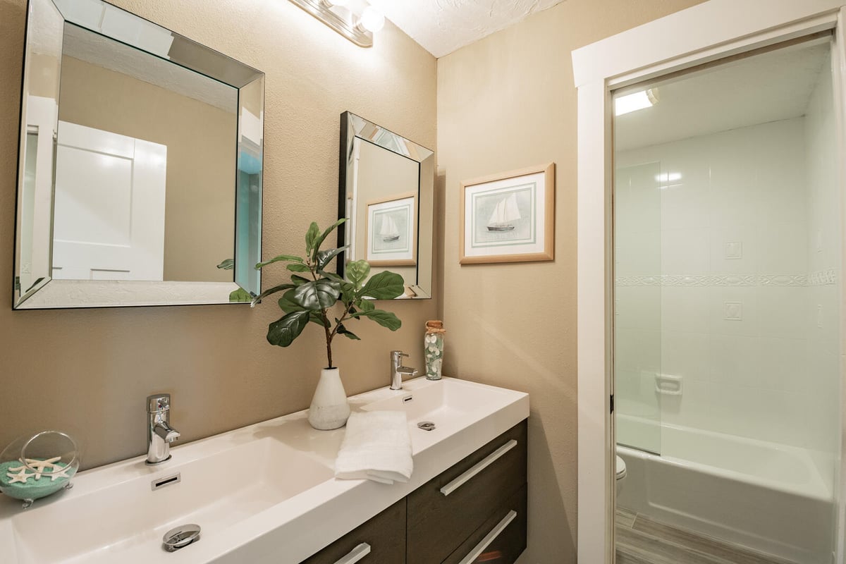 avenida madera guest bathroom with dark wood vanity