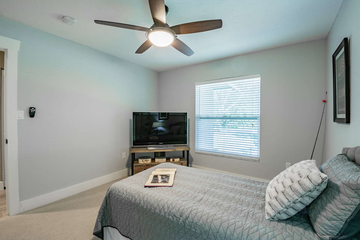 avenida madera guest bedroom ceiling fan and tv