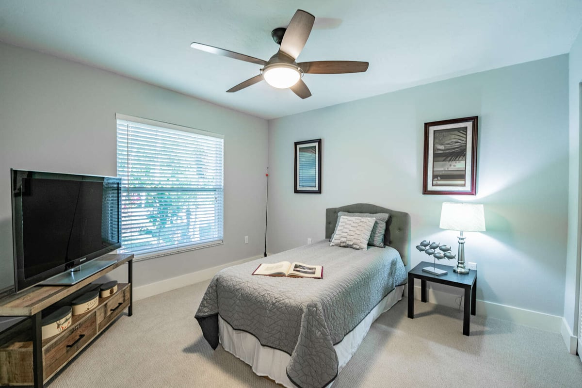 avenida madera guest bedroom with twin bed and tv