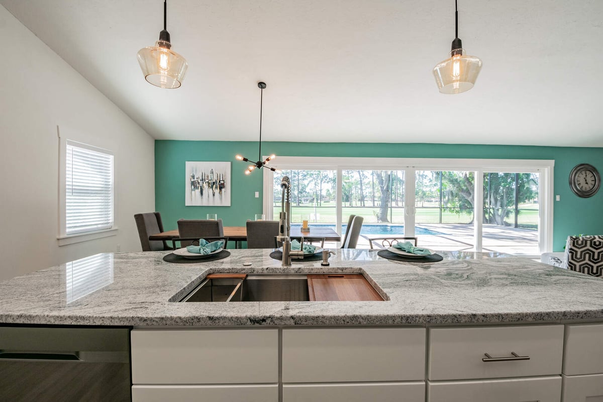 avenida madera kitchen island sink with teal dining wall