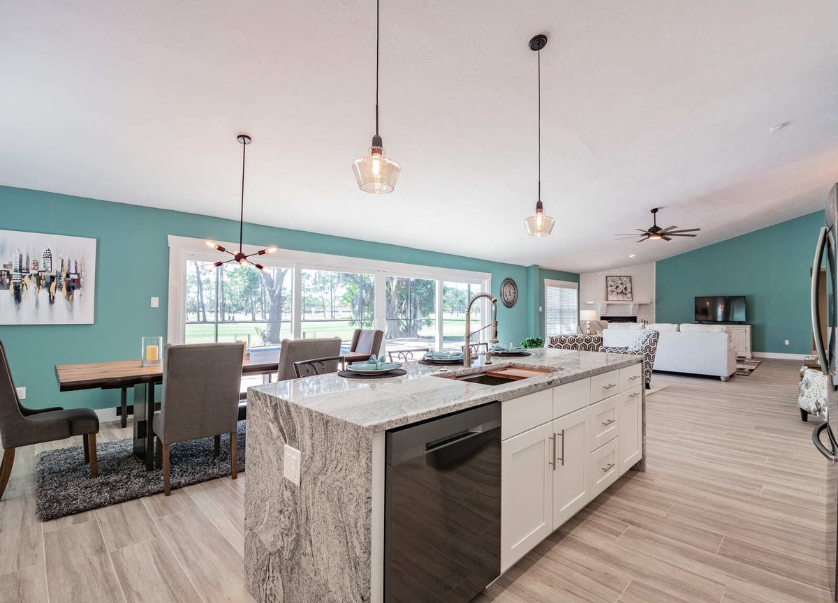 avenida madera kitchen island with dining table and pool view