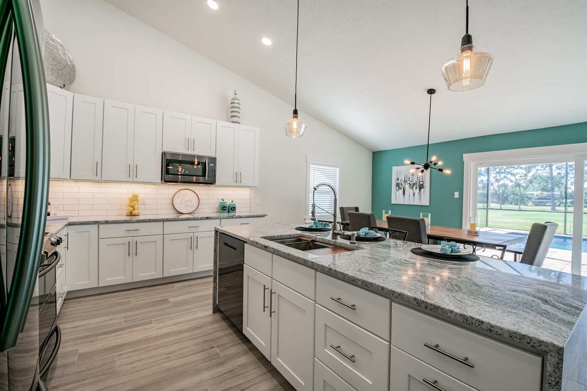 avenida madera kitchen island with teal accent wall dining area
