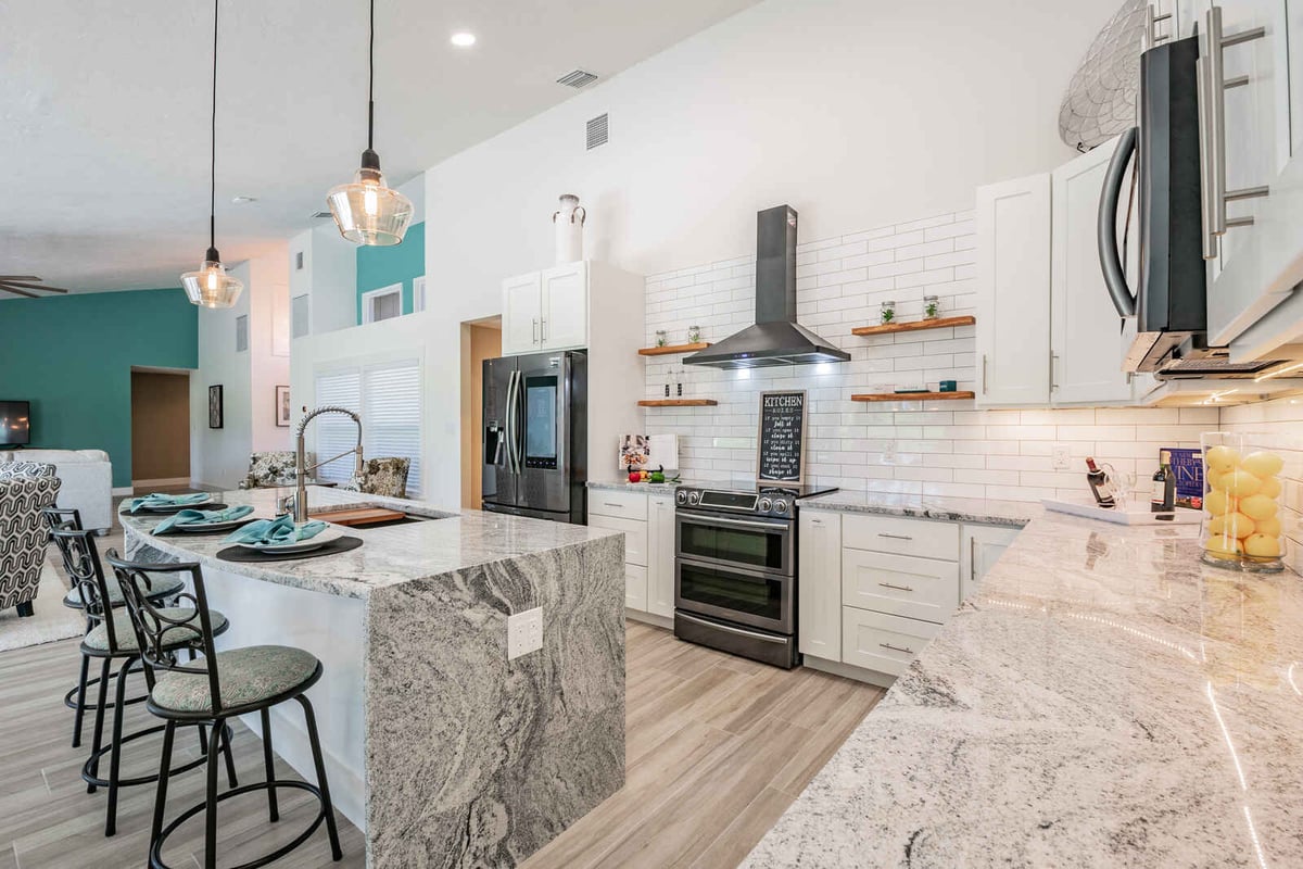 avenida madera kitchen with granite island and bar stools