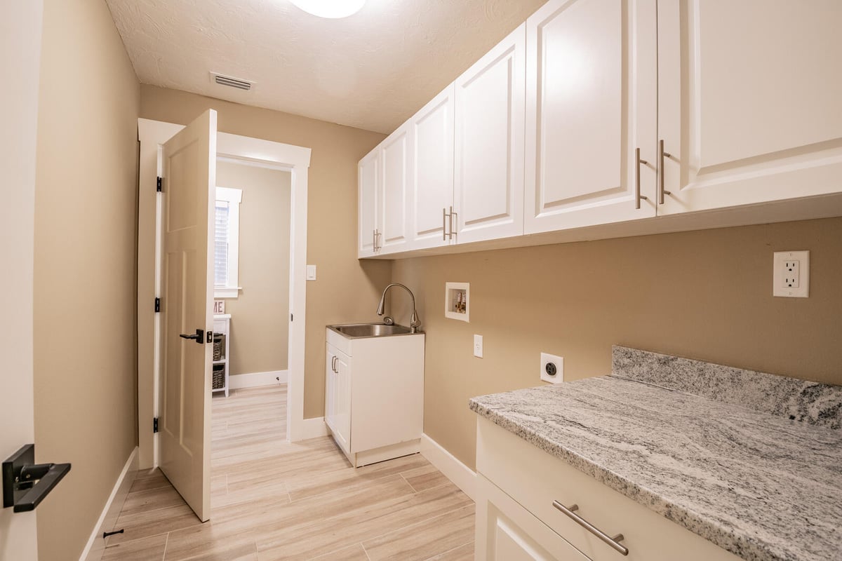 avenida madera laundry room with utility sink and cabinets
