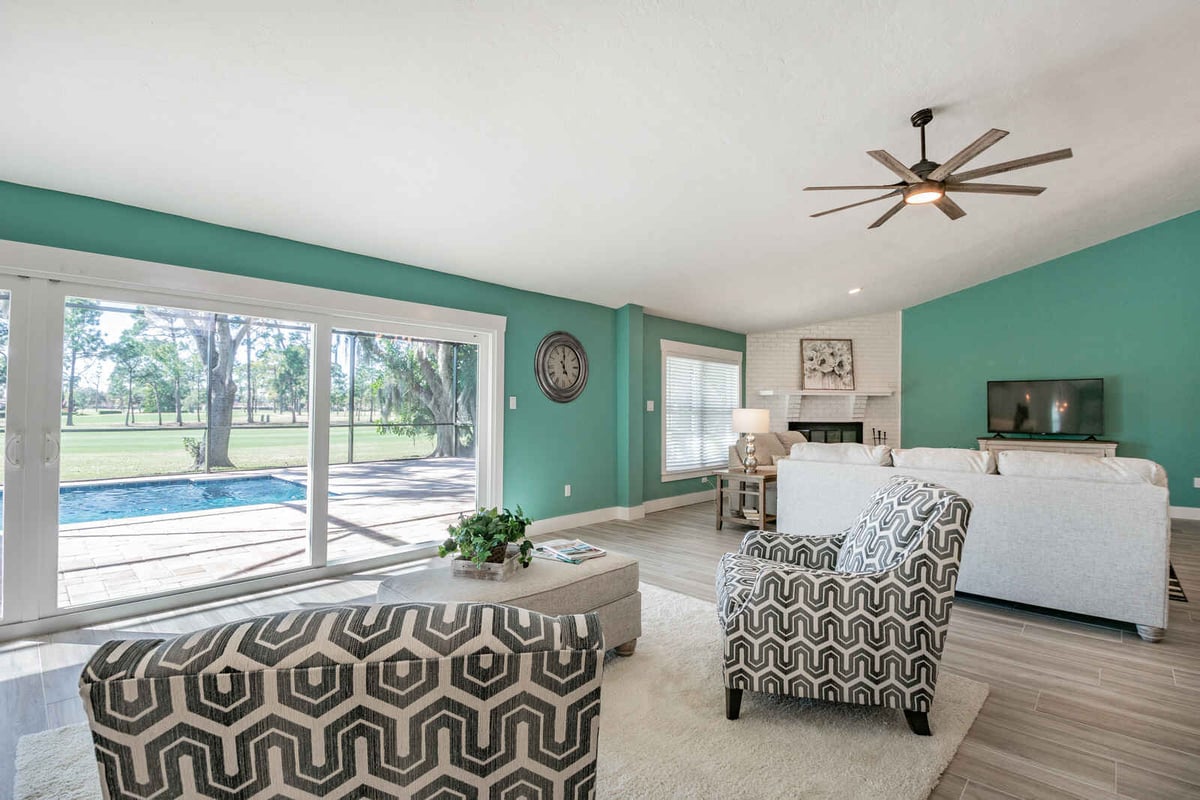 avenida madera living room with sofa and pool view