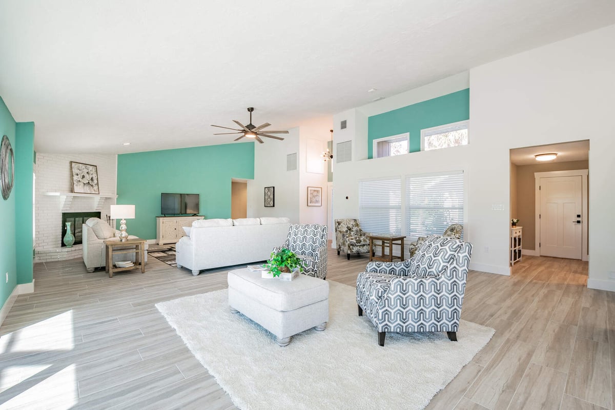 avenida madera living room with teal wall and fireplace