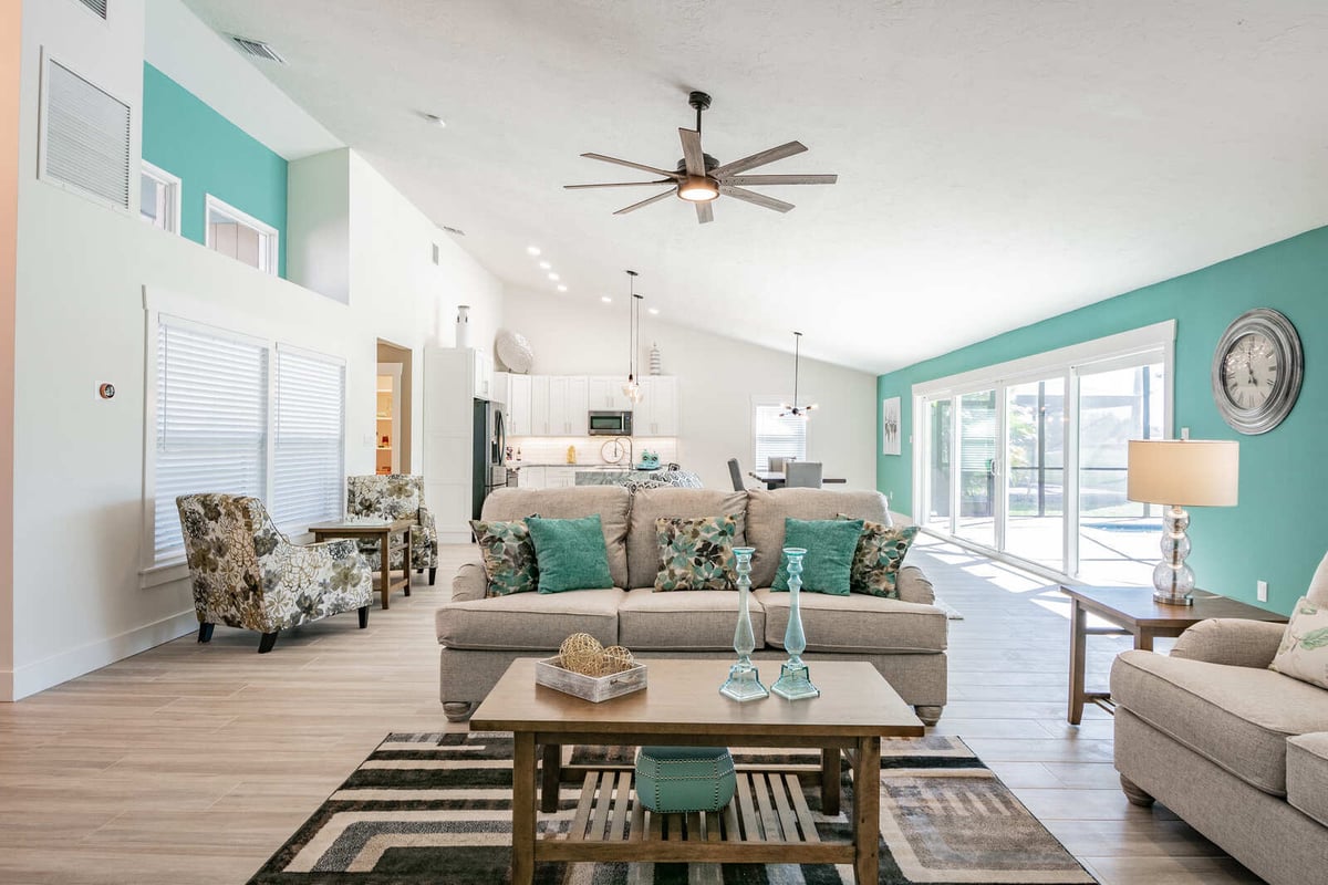 avenida madera living room with teal wall and open kitchen
