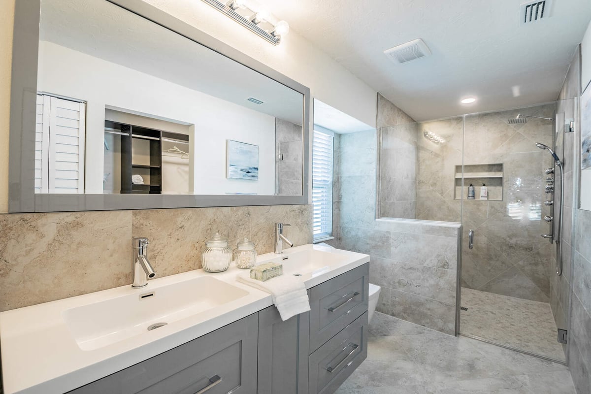 avenida madera primary bathroom with double vanity and walk-in shower