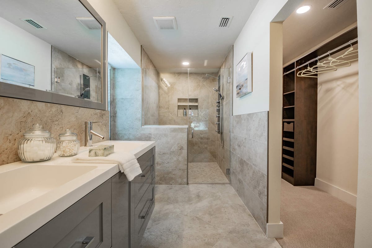 avenida madera primary bathroom with shower and closet view