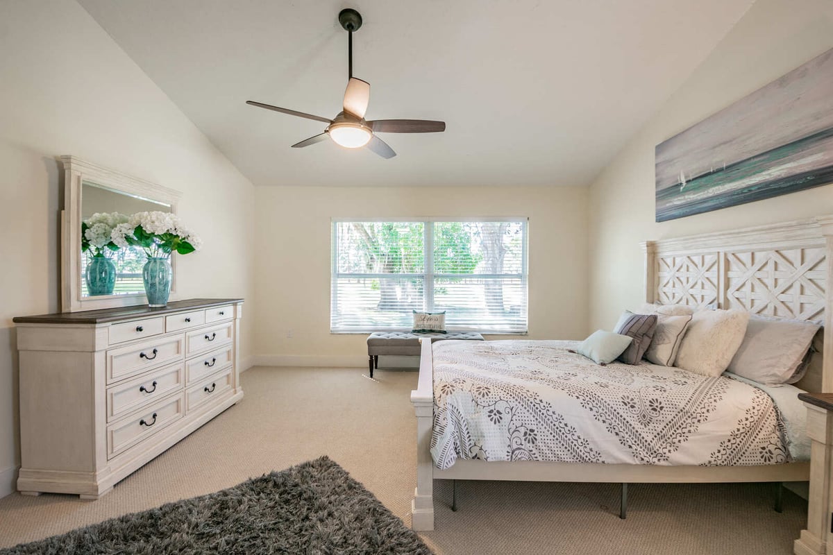 avenida madera primary bedroom with dresser and mirror
