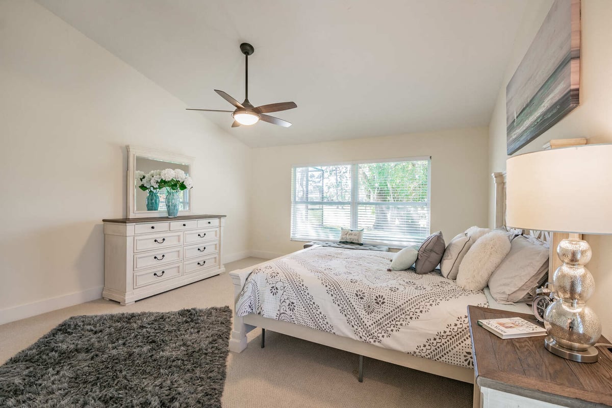 avenida madera primary bedroom with dresser and nightstand