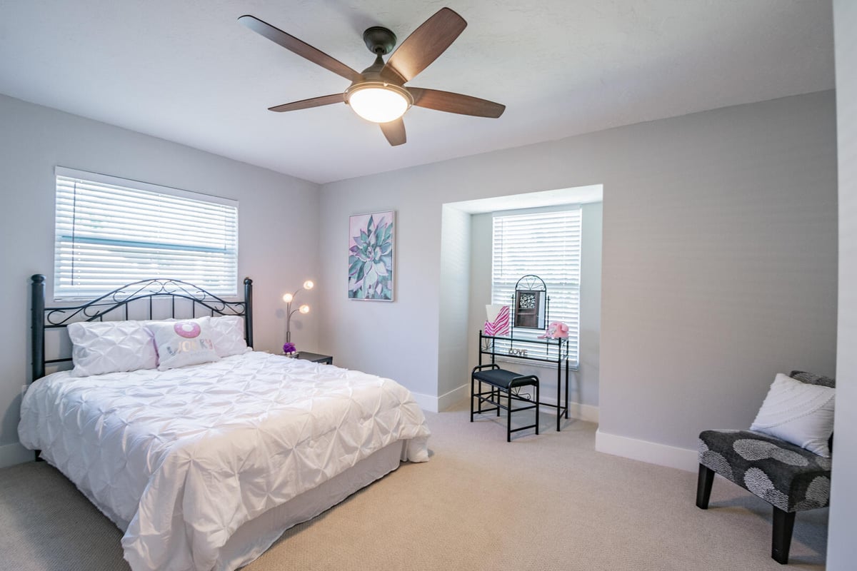 avenida madera primary bedroom wrought iron bed and vanity nook