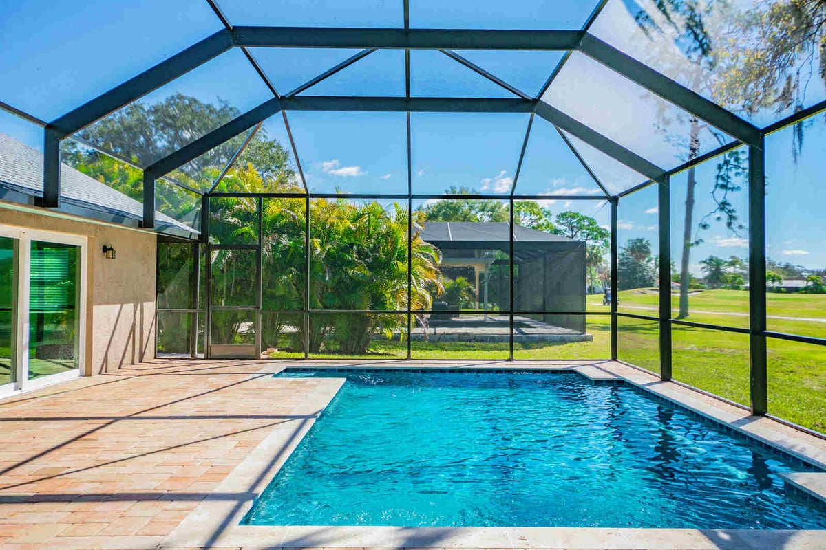 avenida madera screened pool with palm trees and cabana