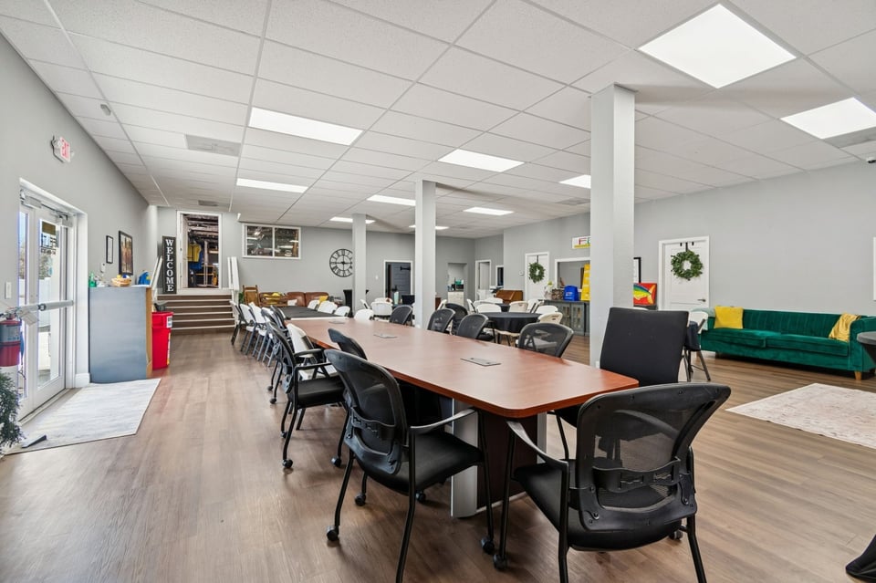Interior_Commercial_Open_Floor_Plan_Conference_Table_Event_Space_Wood_Floors_Drop_Ceiling