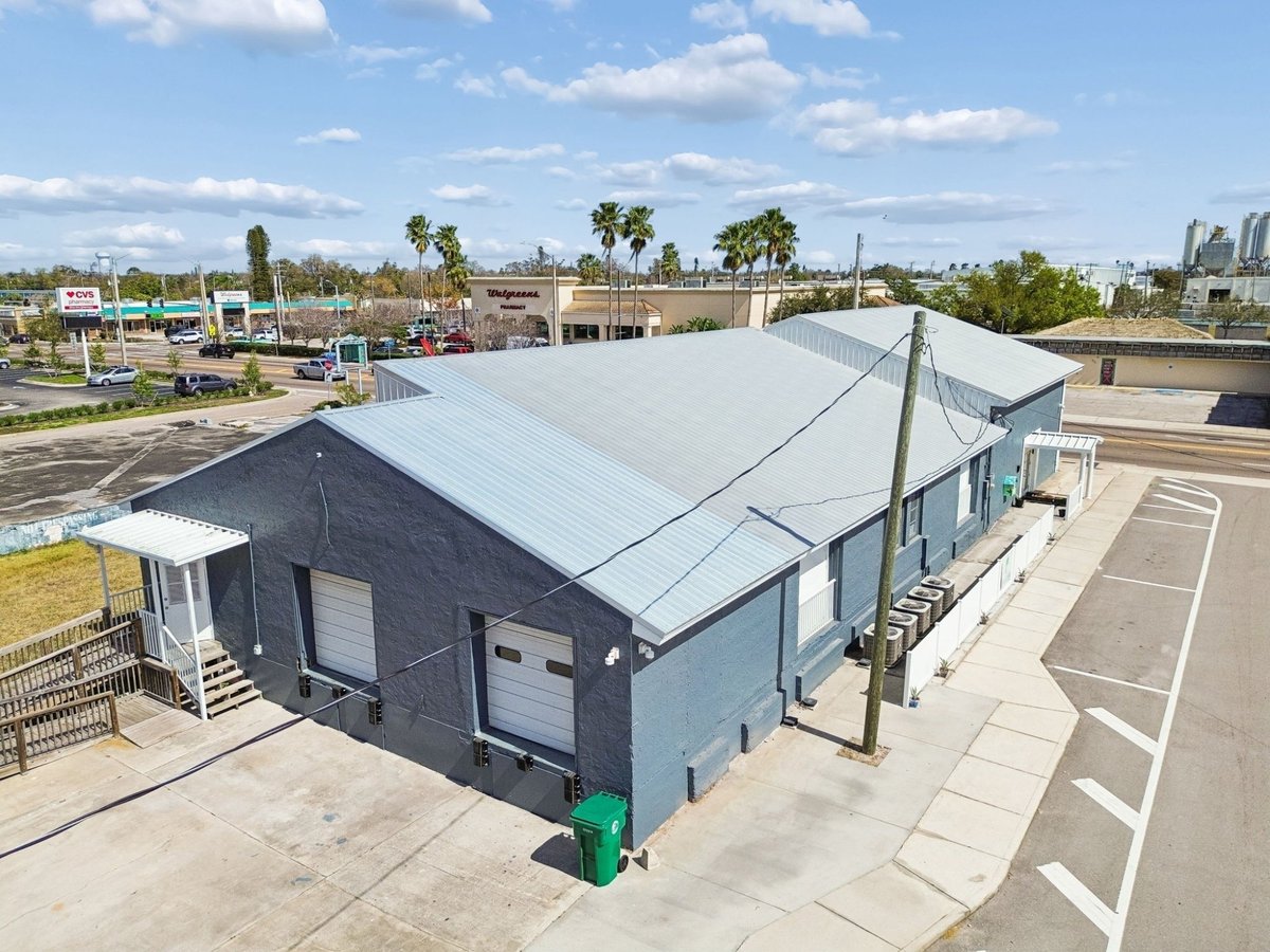 Palmetto Commercial Building Aerial Gray Stucco Metal Roof Corner Lot