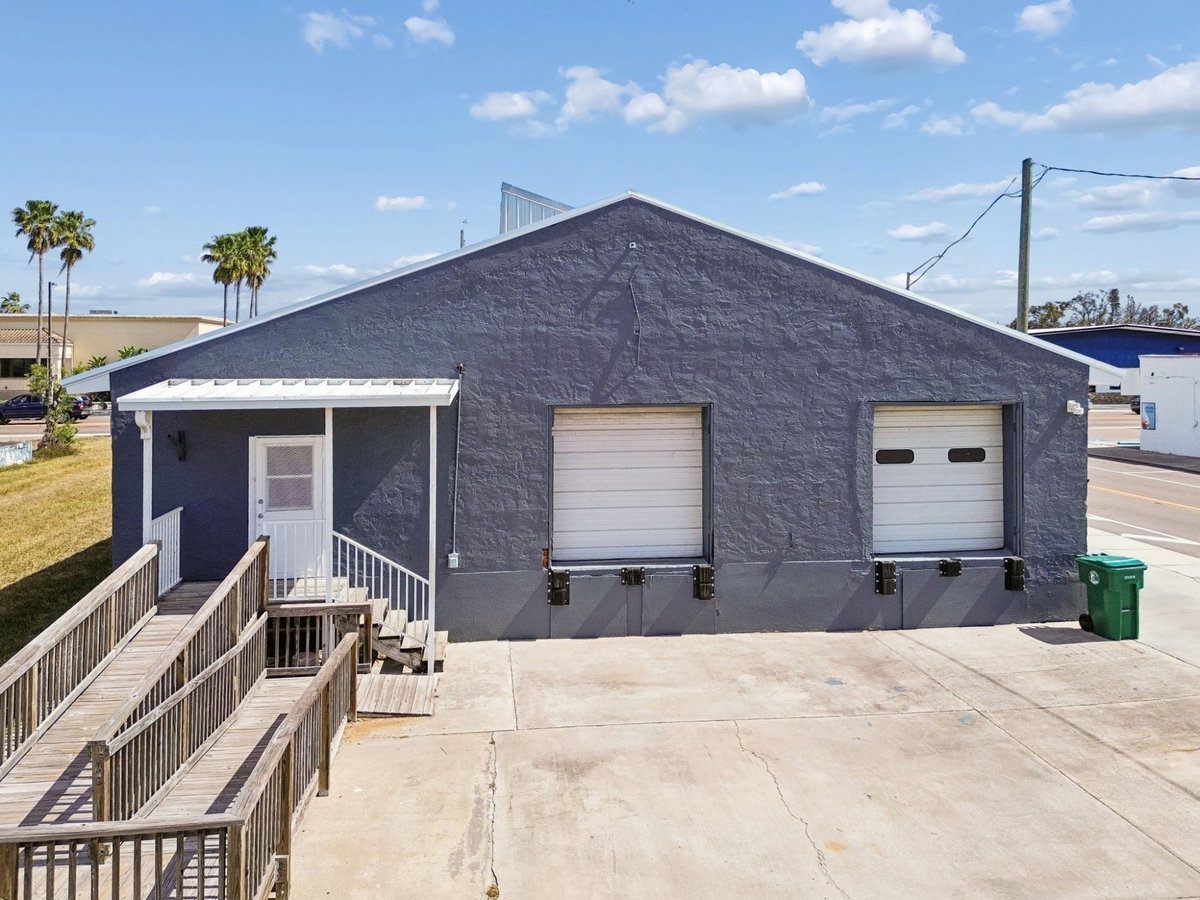 Palmetto Commercial Building Rear Exterior Gray Stucco Double Garage Doors Ramp