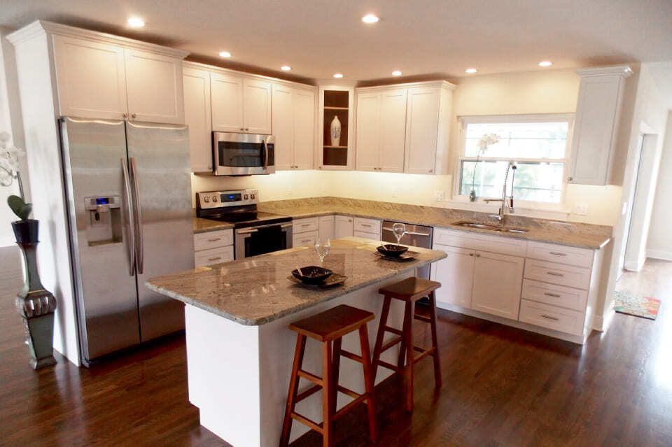 Custom kitchen with recessed lighting and granite island by Adkins Building & Construction in Bradenton, FL