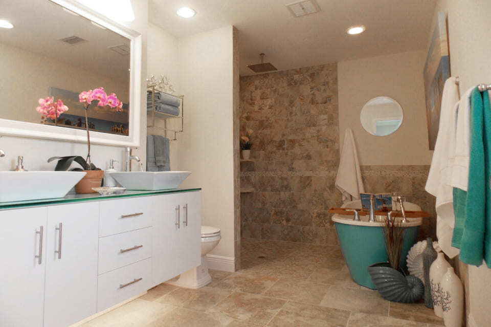 Elegant bathroom upgrade in Bradenton featuring glass vanity and spa tub by Adkins Building & Construction.-2