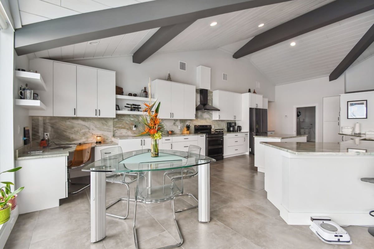 Bright, modern kitchen with open shelving and water views in custom Bradenton home by Adkins Building & Construction. - 5