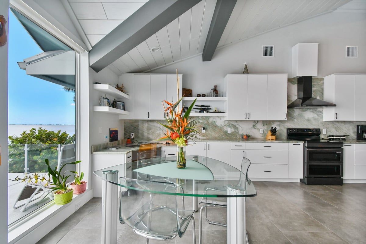 Close-up of modern custom home front entry with stone accents and black railings in Bradenton, FL. - 4