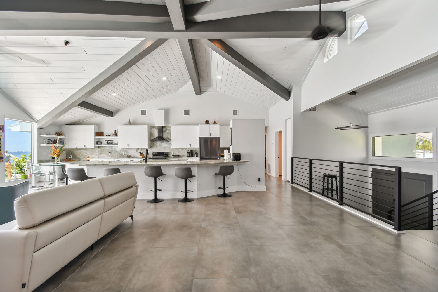 Open-concept kitchen and living space with vaulted ceiling in Bradenton, FL custom home by Adkins Building & Construction.