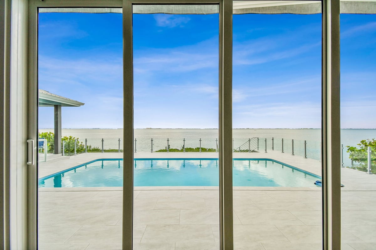 Panoramic bay view from poolside patio in Bradenton, FL custom home by Adkins Building & Construction.