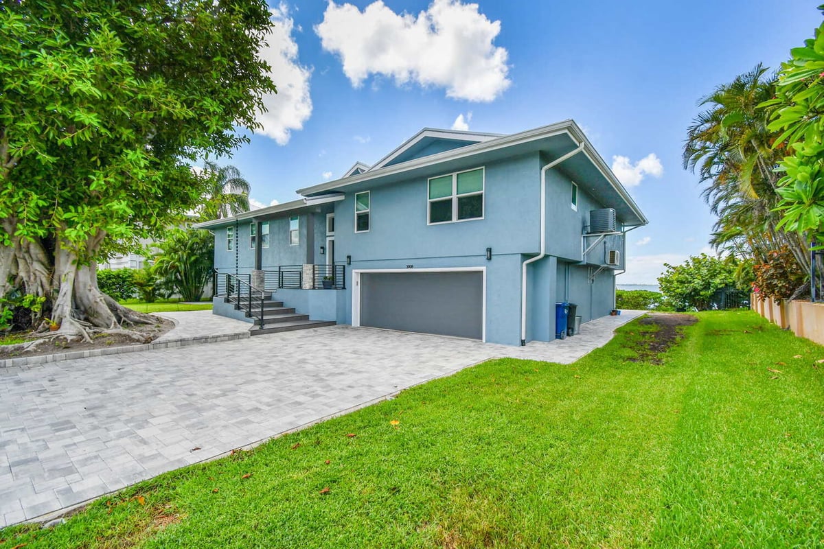 Renovated backyard of custom home in Bradenton, FL featuring raised pool and fencing by Adkins Building & Construction. - 2