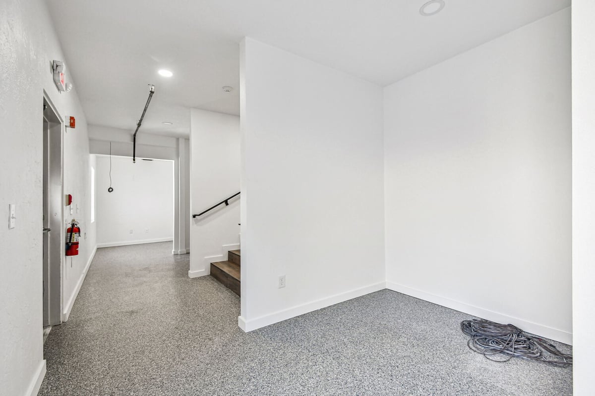 Back hallway with epoxy floors in custom church project by Adkins Building & Construction in Anna Maria, FL