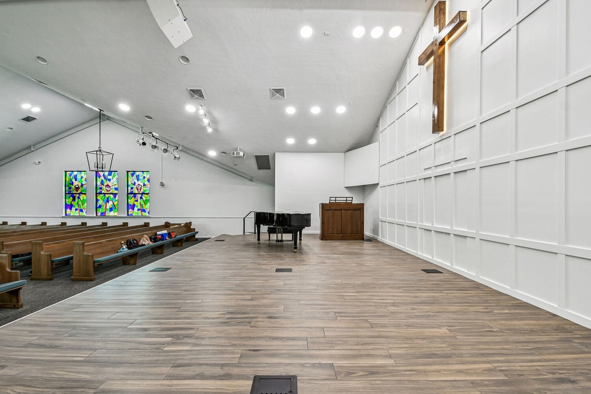 Sanctuary side angle showing stained glass windows and elevated stage by Adkins in Anna Maria, FL