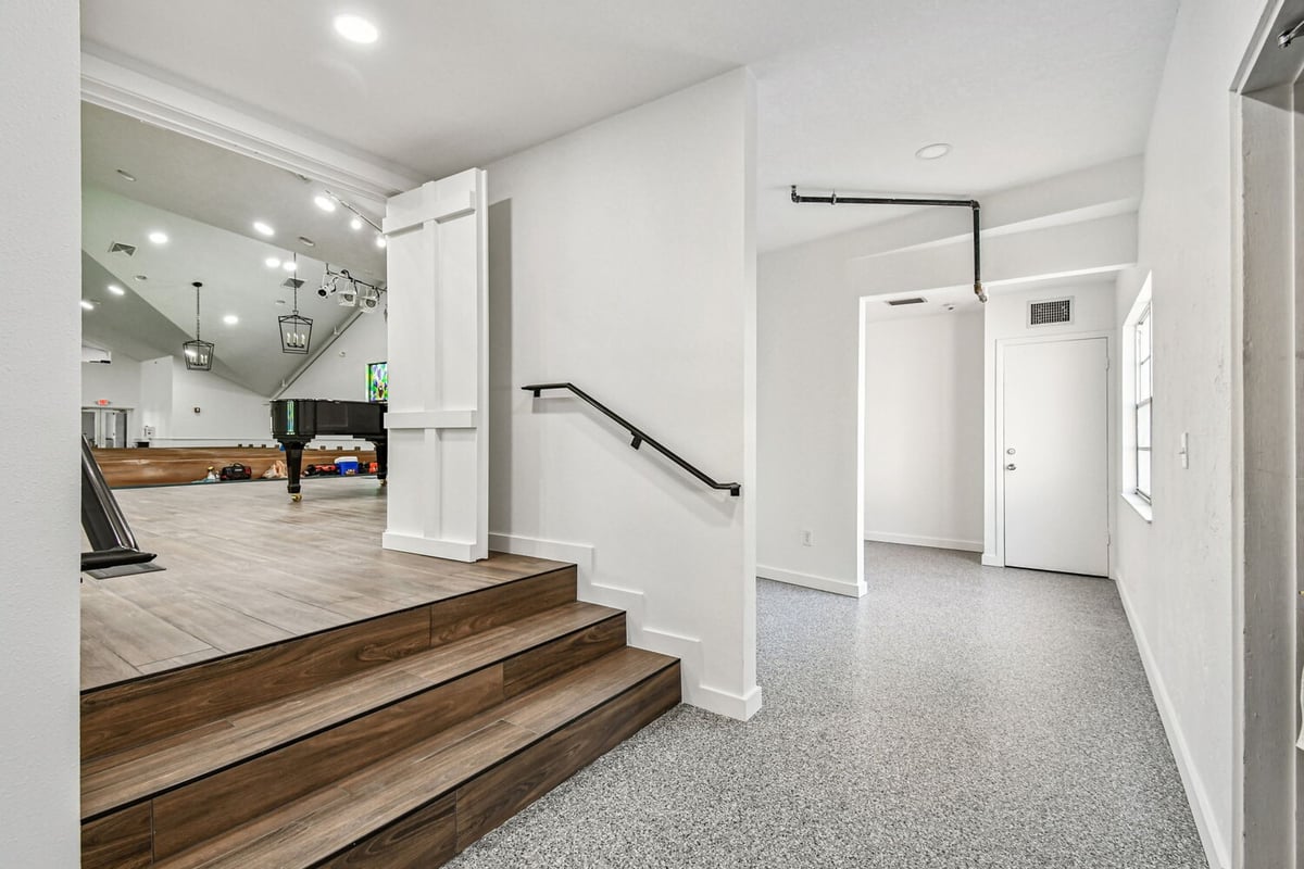 Transition space with wood steps leading to sanctuary in custom home project by Adkins Building & Construction in Anna Maria, FL