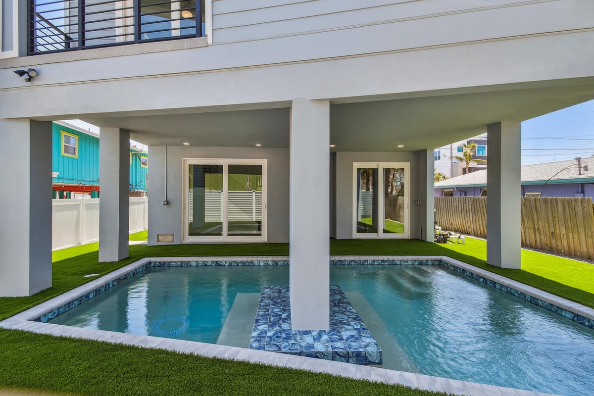 Covered poolside patio of custom home in Bradenton, FL by Adkins Building & Construction