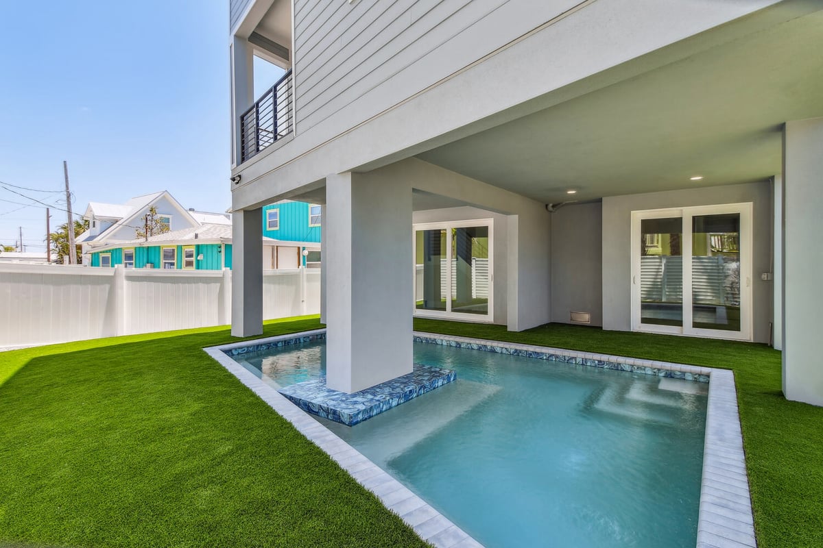 Elevated pool and green lawn at Bradenton Beach custom build by Adkins Building & Construction