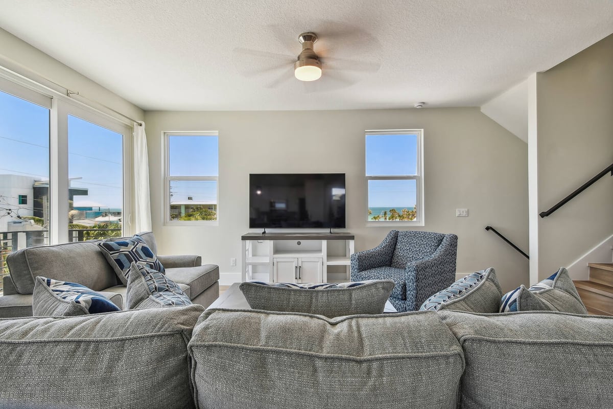 Living room with coastal decor and ocean views in a Holmes Beach custom home by Adkins Building & Construction