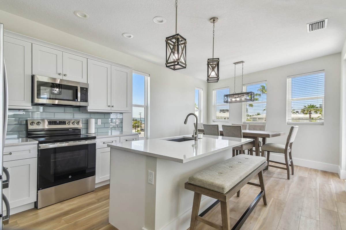 Open kitchen and dining space in a Longboat Key custom home by Adkins Building & Construction