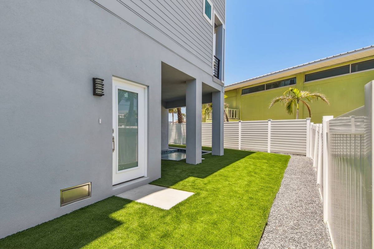 Private side entrance and yard of Bradenton custom home by Adkins Building & Construction