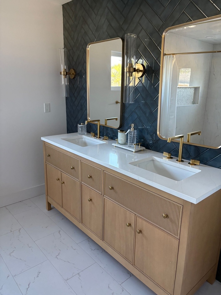 Close-up of high-end bathroom vanity with gold accents in custom home by Adkins Building & Construction, Longboat Key, FL.