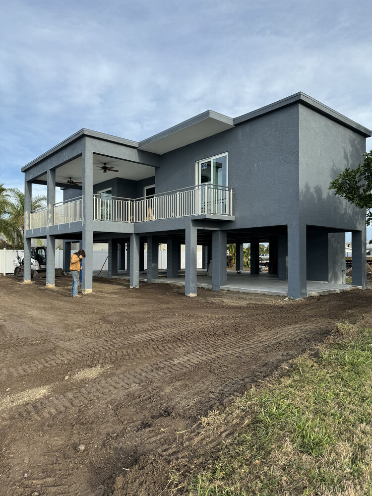 Finished custom waterfront home with elevated design by Adkins Building & Construction in Bradenton, FL.