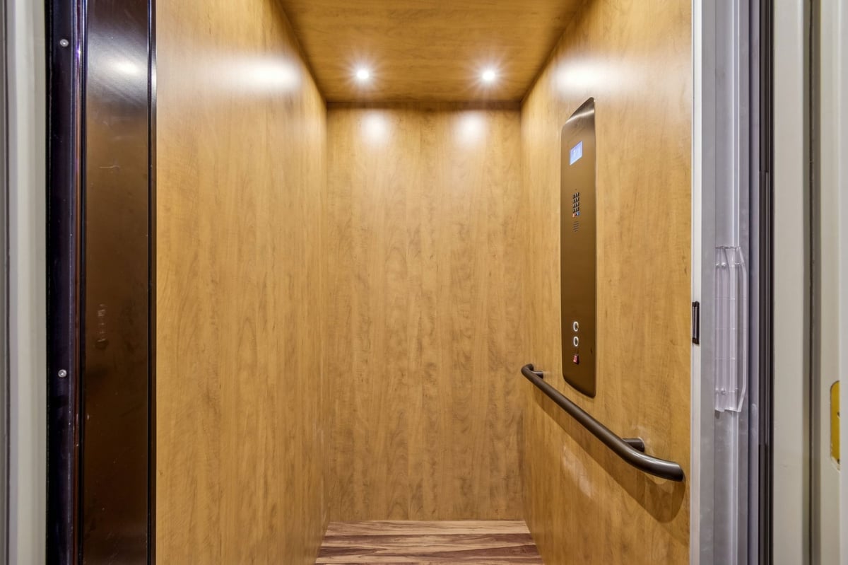 Interior Private Elevator Wood Paneled Cab Recessed Lighting Handrail