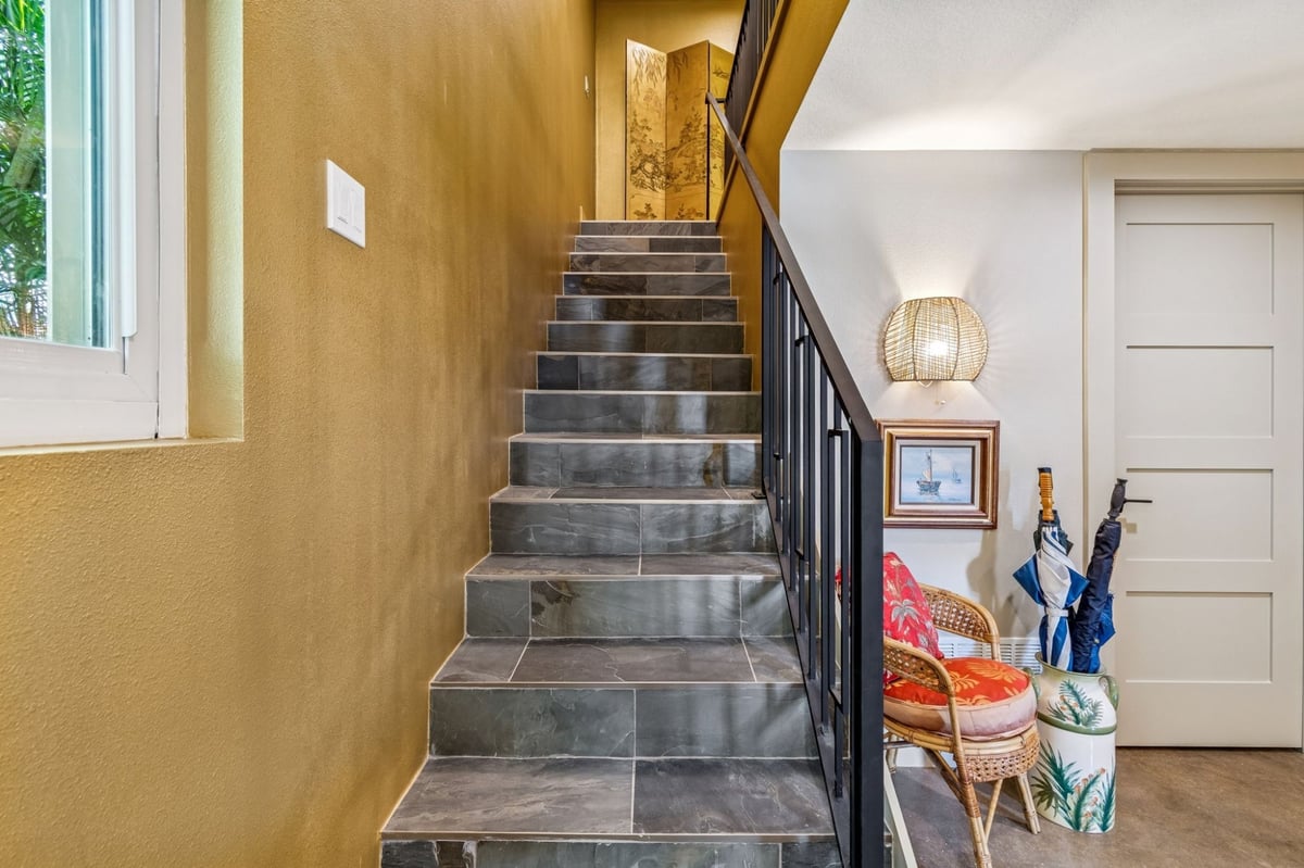 Interior Staircase Slate Tile Steps Iron Railing Gold Accent Wall