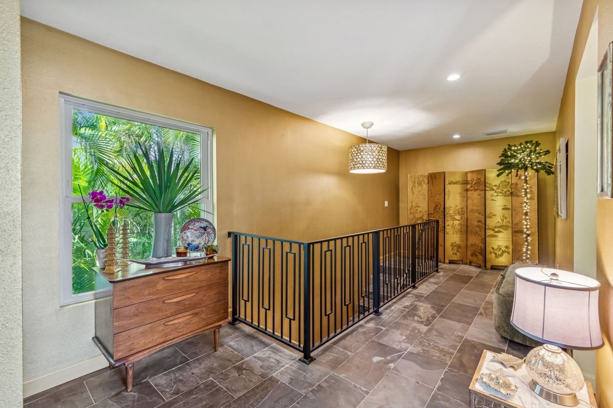 Interior Upper Hallway Gold Walls Iron Railing