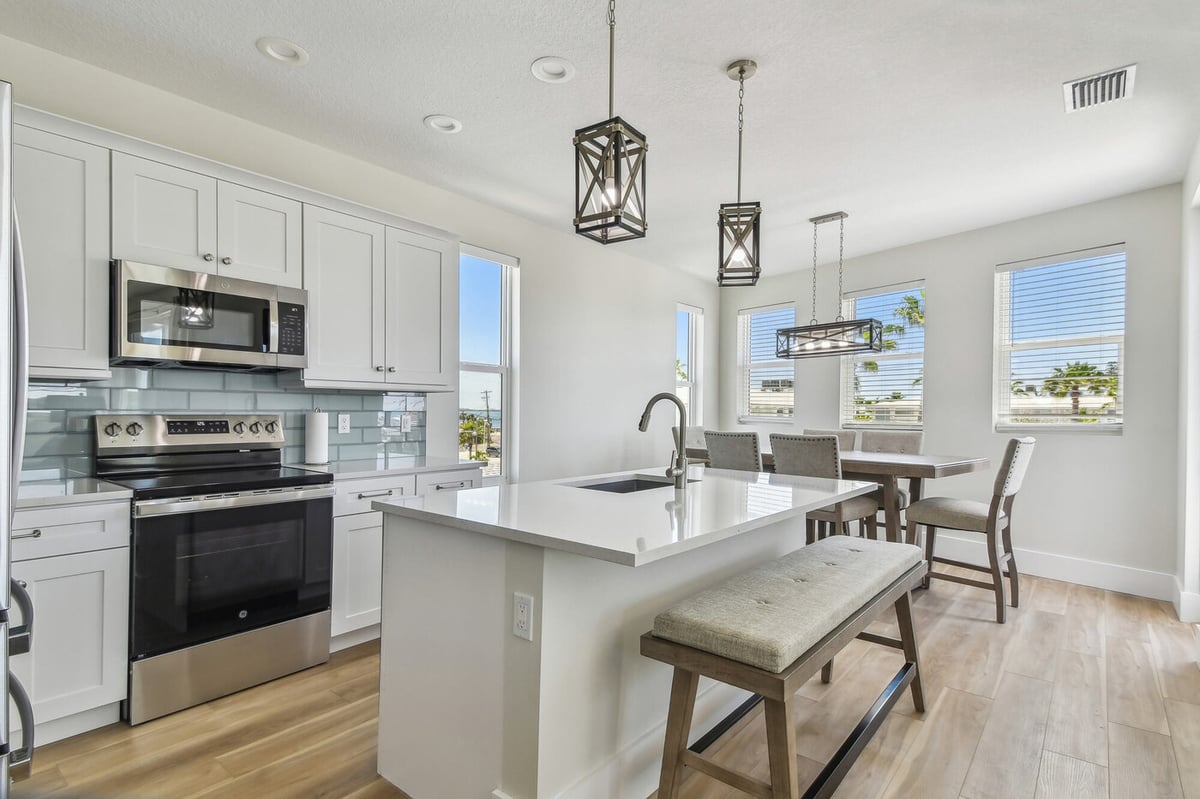 Open kitchen and dining space in a Longboat Key custom home by Adkins Building &amp; Construction