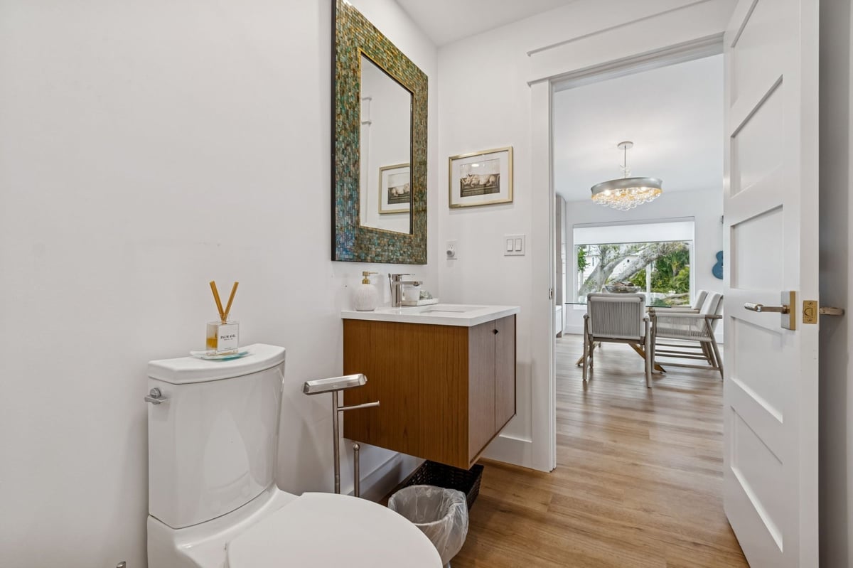 Interior Guest Bath Floating Vanity Mosaic Mirror View To Dining Room