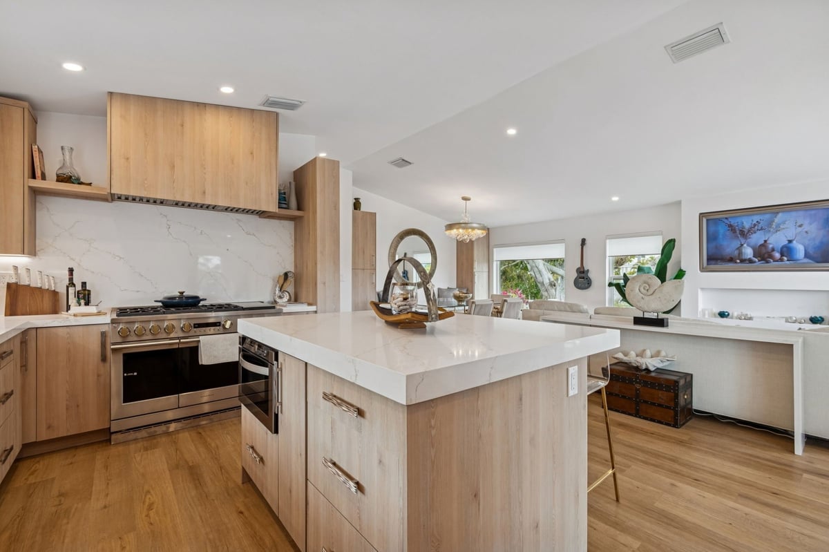 Interior Kitchen Gas Range Wood Hood Island Open To Living Room Chandelier
